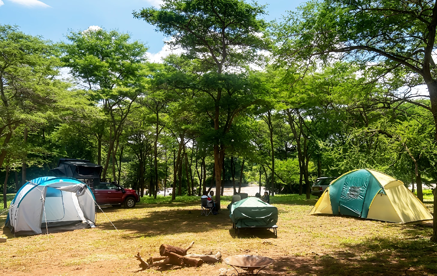 A panoramic aerial view of Thiba River Camp beside the river and open Embu landscape